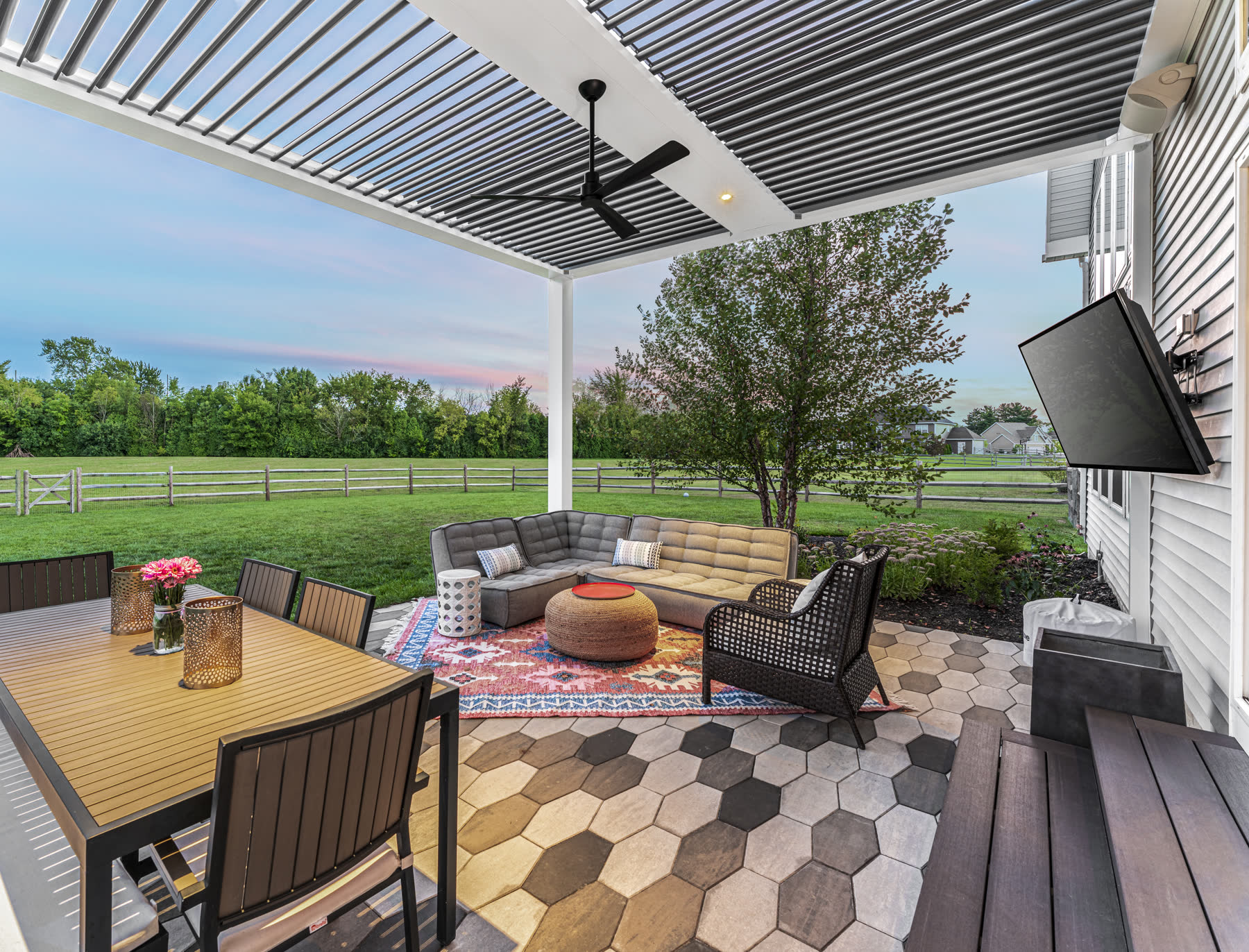 A twilight patio under a motorized pergola